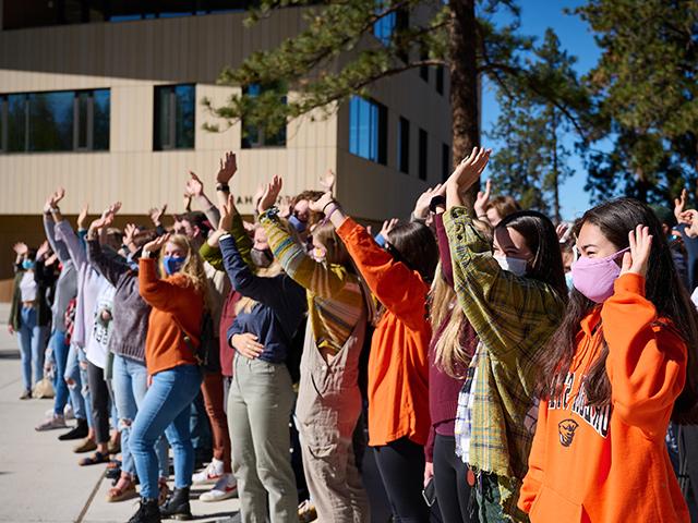 people standing in a line waving